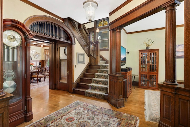 880 Fairmount Ave, Saint Paul, MN 55105 - entrance foyer featuring decorative columns, wood finished floors, and stairs