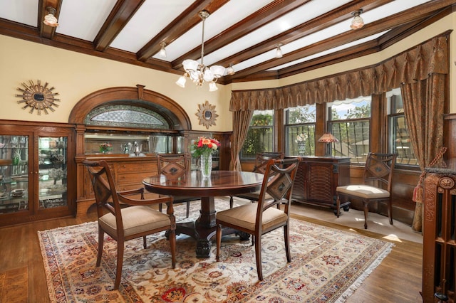 880 Fairmount Ave, Saint Paul, MN 55105 - dining area featuring beam ceiling, a chandelier, a wainscoted wall, and wood finished floors