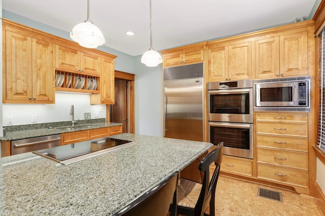880 Fairmount Ave, Saint Paul, MN 55105 - kitchen featuring built in appliances, a kitchen bar, hanging light fixtures, light stone countertops, and recessed lighting
