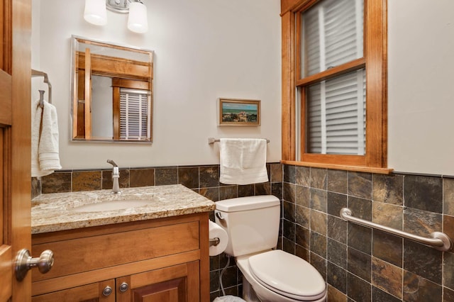 880 Fairmount Ave, Saint Paul, MN 55105 - half bathroom featuring tile walls, wainscoting, and vanity