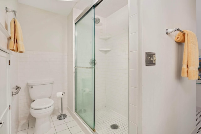 880 Fairmount Ave, Saint Paul, MN 55105 - full bathroom featuring a shower stall, tile patterned flooring, tile walls, and a wainscoted wall