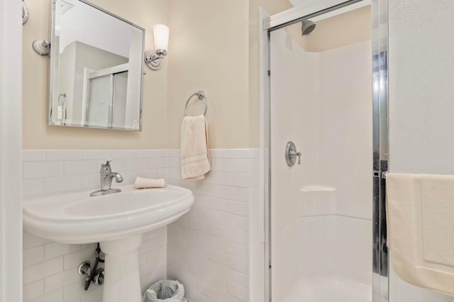 880 Fairmount Ave, Saint Paul, MN 55105 - full bathroom with a shower stall, tile walls, and a wainscoted wall
