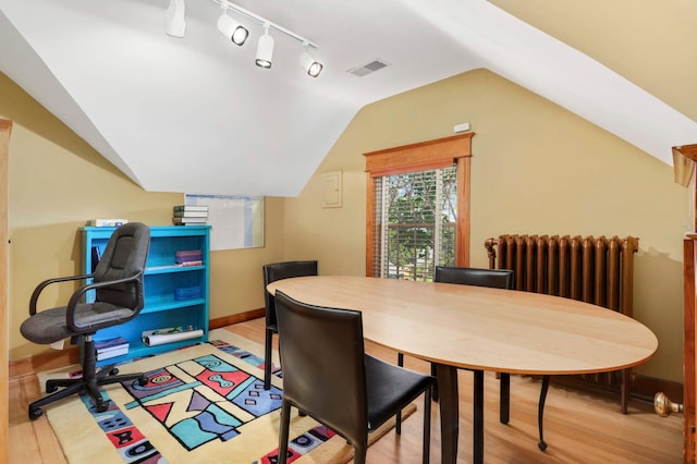 880 Fairmount Ave, Saint Paul, MN 55105 - dining area with light wood-type flooring, lofted ceiling, track lighting, and radiator