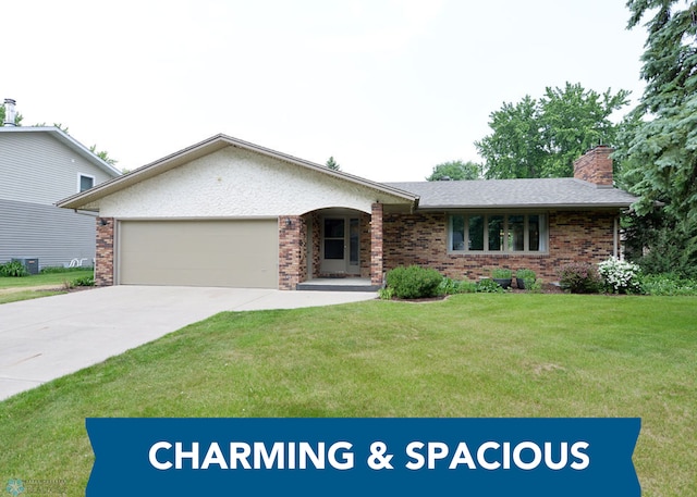 507 24th Ave S, Fargo, ND 58103 - view of front of property featuring an attached garage, concrete driveway, a front yard, and brick siding