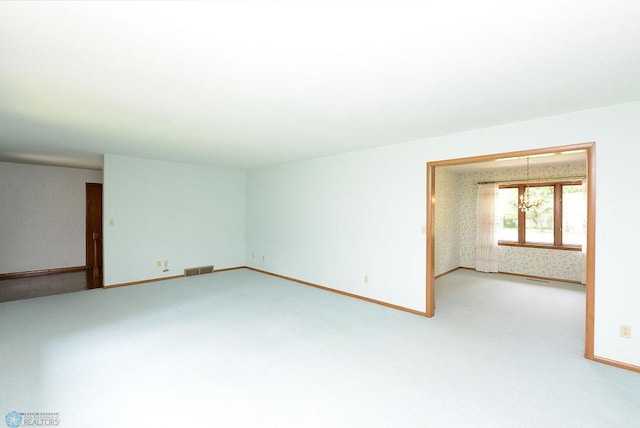 507 24th Ave S, Fargo, ND 58103 - unfurnished room with light carpet, a chandelier, and wallpapered walls