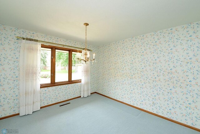 507 24th Ave S, Fargo, ND 58103 - carpeted spare room featuring a chandelier and wallpapered walls