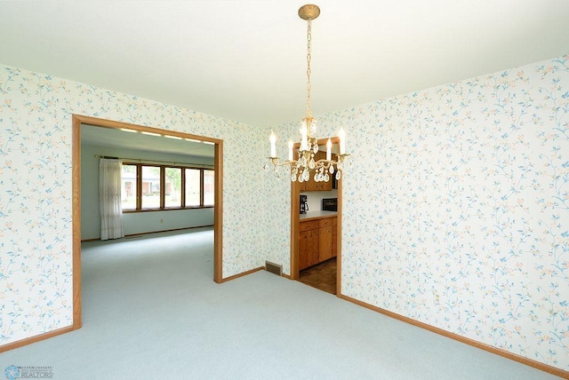 507 24th Ave S, Fargo, ND 58103 - carpeted spare room with a chandelier and wallpapered walls