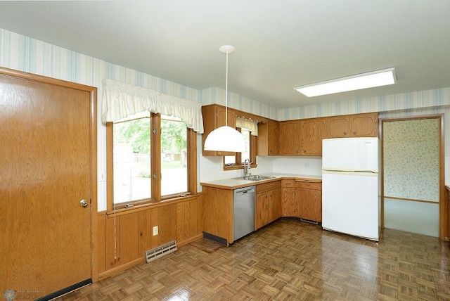 507 24th Ave S, Fargo, ND 58103 - kitchen with freestanding refrigerator, dishwasher, wallpapered walls, and light countertops