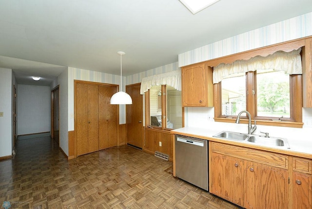 507 24th Ave S, Fargo, ND 58103 - kitchen with stainless steel dishwasher, light countertops, hanging light fixtures, and brown cabinets