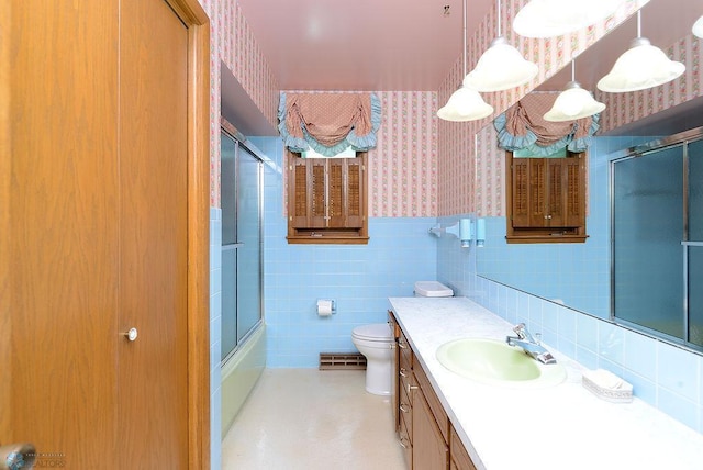 507 24th Ave S, Fargo, ND 58103 - full bath with wallpapered walls, vanity, a wainscoted wall, combined bath / shower with glass door, and tile walls