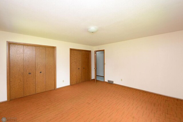 507 24th Ave S, Fargo, ND 58103 - unfurnished bedroom featuring two closets and light colored carpet
