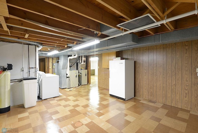 507 24th Ave S, Fargo, ND 58103 - finished basement with washing machine and dryer, light floors, freestanding refrigerator, wood walls, and heating unit