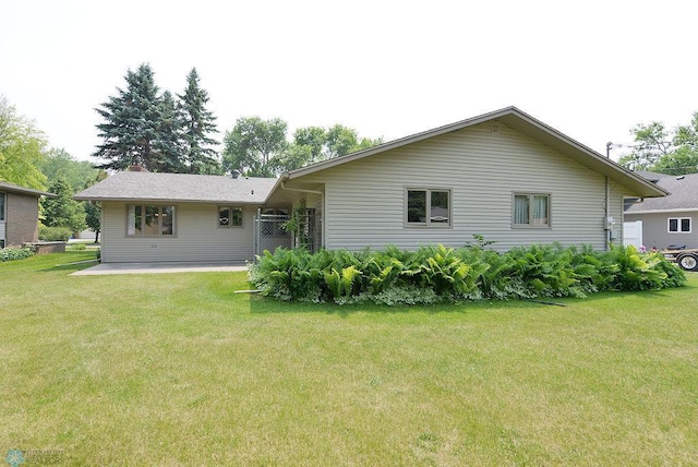 507 24th Ave S, Fargo, ND 58103 - rear view of property with a lawn, a patio, and a chimney