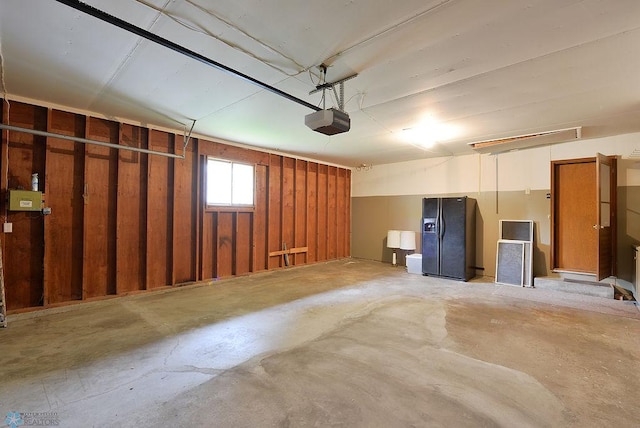 507 24th Ave S, Fargo, ND 58103 - garage with black fridge with ice dispenser and a garage door opener