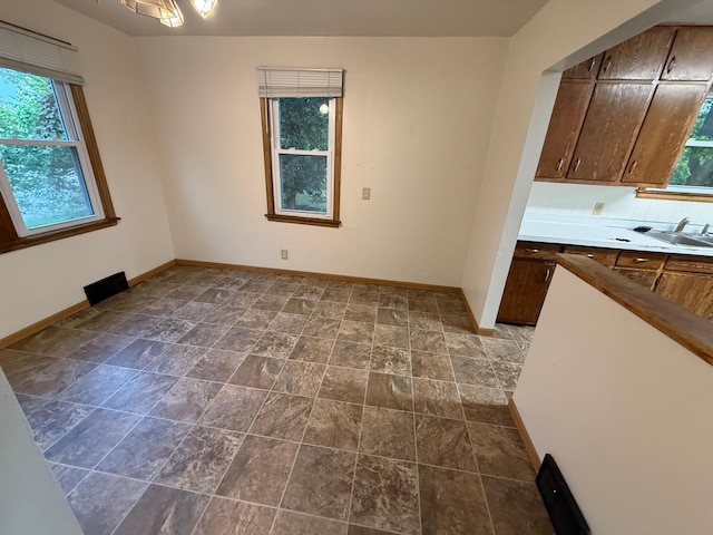 19 1st Ave NE, Saint Joseph, MN 56374 - kitchen featuring plenty of natural light, baseboards, and a sink