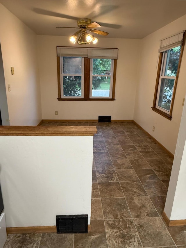 19 1st Ave NE, Saint Joseph, MN 56374 - unfurnished room featuring plenty of natural light, ceiling fan, and baseboards