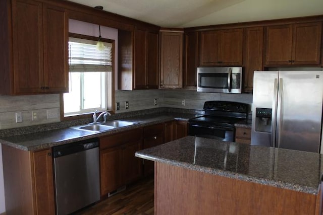 1027 Taft St S, Cambridge, MN 55008 - kitchen with appliances with stainless steel finishes, backsplash, dark wood-type flooring, vaulted ceiling, and dark stone counters