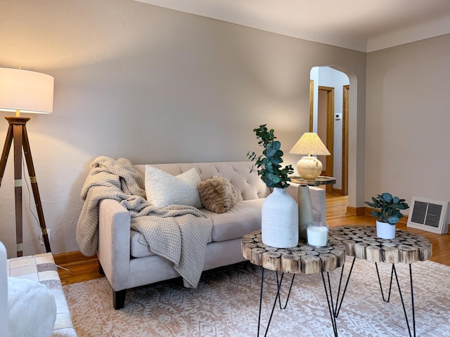 1759 Arlington Ave E, Saint Paul, MN 55106 - living room with arched walkways, wood finished floors, and baseboards