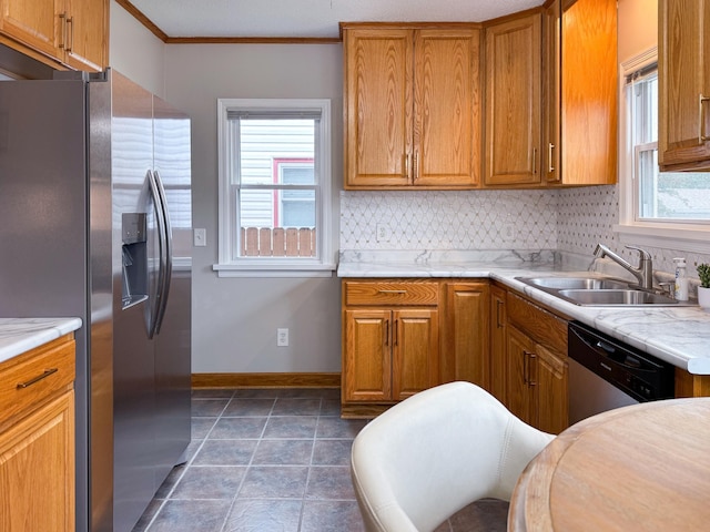 1759 Arlington Ave E, Saint Paul, MN 55106 - kitchen with appliances with stainless steel finishes, a sink, baseboards, light countertops, and brown cabinetry
