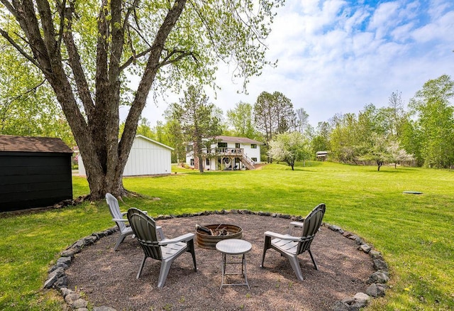 315 Pleasant View Rd, Duluth, MN 55803 - view of grassy yard with an outdoor fire pit, a deck, and stairs