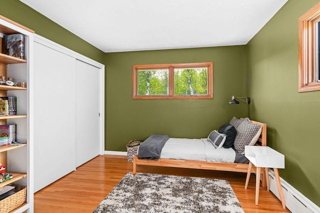 315 Pleasant View Rd, Duluth, MN 55803 - bedroom featuring baseboard heating, wood finished floors, and a closet