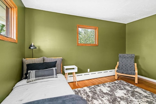 315 Pleasant View Rd, Duluth, MN 55803 - bedroom featuring baseboard heating, wood finished floors, and baseboards