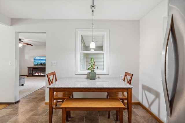 8400 Virginia Cir S, Saint Louis Park, MN 55426 - dining room featuring baseboards, a ceiling fan, and a glass covered fireplace