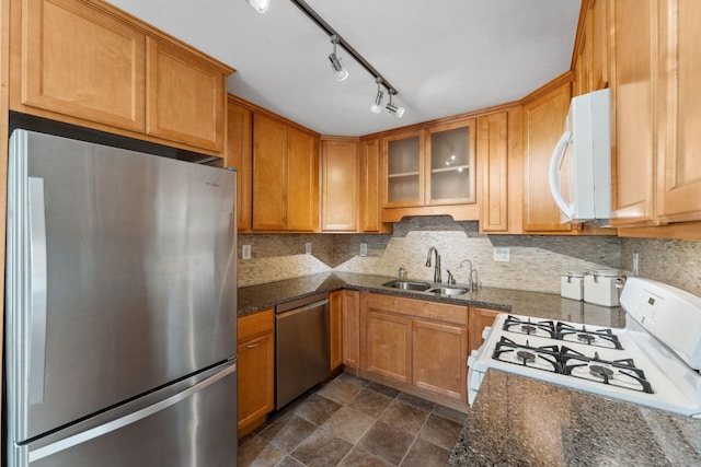 8400 Virginia Cir S, Saint Louis Park, MN 55426 - kitchen featuring stainless steel appliances, a sink, backsplash, glass insert cabinets, and dark stone counters