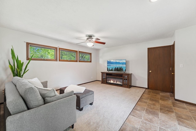 8400 Virginia Cir S, Saint Louis Park, MN 55426 - living area with a ceiling fan, a glass covered fireplace, baseboards, and stone finish floors