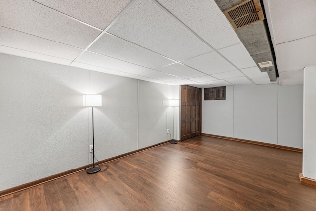 8400 Virginia Cir S, Saint Louis Park, MN 55426 - finished below grade area with baseboards, dark wood-style flooring, and a paneled ceiling