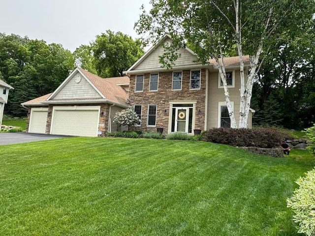 1496 Pinetree Trl, Eagan, MN 55122 - view of front of home with stone siding, a front yard, asphalt driveway, and a garage