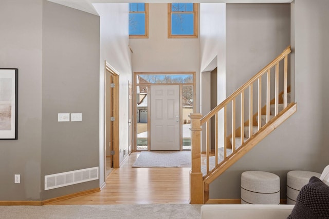 1496 Pinetree Trl, Eagan, MN 55122 - foyer entrance featuring wood finished floors, a high ceiling, stairs, and baseboards