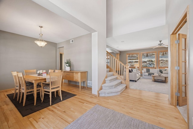 1496 Pinetree Trl, Eagan, MN 55122 - dining space featuring wood finished floors, stairs, ceiling fan, and baseboards