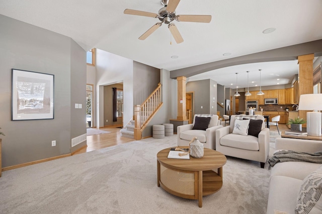 1496 Pinetree Trl, Eagan, MN 55122 - living room with ornate columns, light carpet, a ceiling fan, baseboards, and stairway