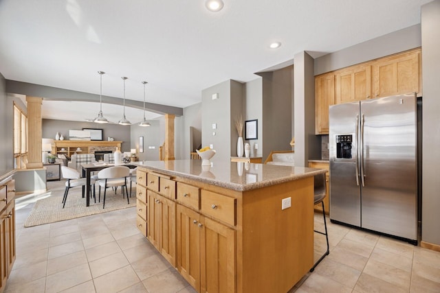 1496 Pinetree Trl, Eagan, MN 55122 - kitchen with stainless steel refrigerator with ice dispenser, decorative columns, a center island, light tile patterned floors, and open floor plan