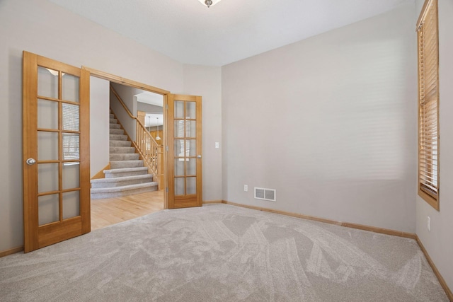1496 Pinetree Trl, Eagan, MN 55122 - carpeted empty room featuring french doors, stairway, and baseboards