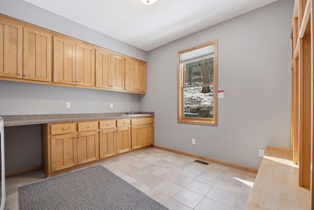 1496 Pinetree Trl, Eagan, MN 55122 - kitchen with baseboards, a sink, light tile patterned flooring, and light countertops