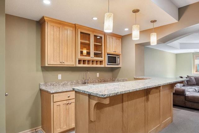 1496 Pinetree Trl, Eagan, MN 55122 - kitchen with open floor plan, stainless steel microwave, a breakfast bar, light brown cabinets, and glass insert cabinets