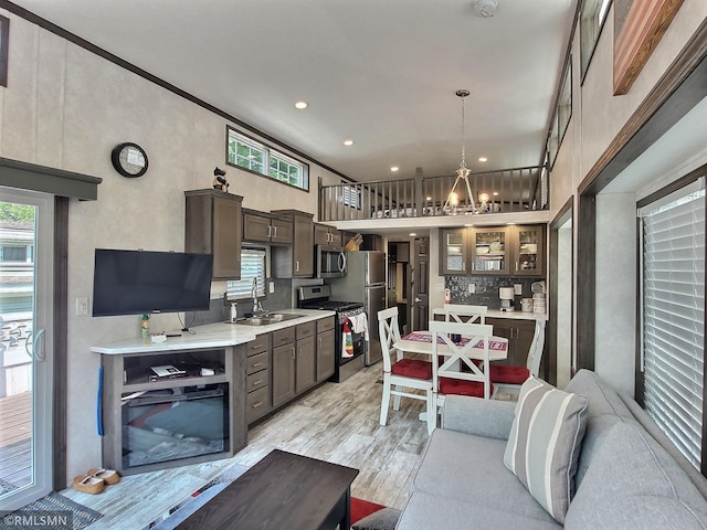 10255 Nevens Ave NW Unit 50, South Haven, MN 55382 - kitchen featuring appliances with stainless steel finishes, a sink, dark brown cabinetry, light wood-style floors, and light countertops