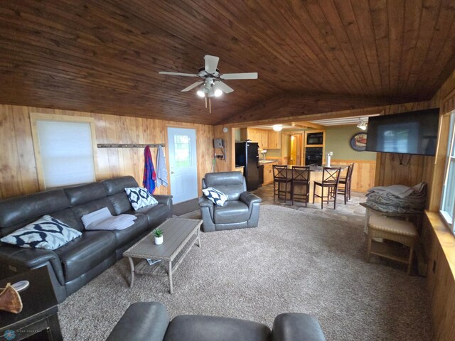 14768 Tradewinds Rd, Lake Eunice Twp, MN 56511 - living room with wood walls, lofted ceiling, wood ceiling, a ceiling fan, and dark colored carpet