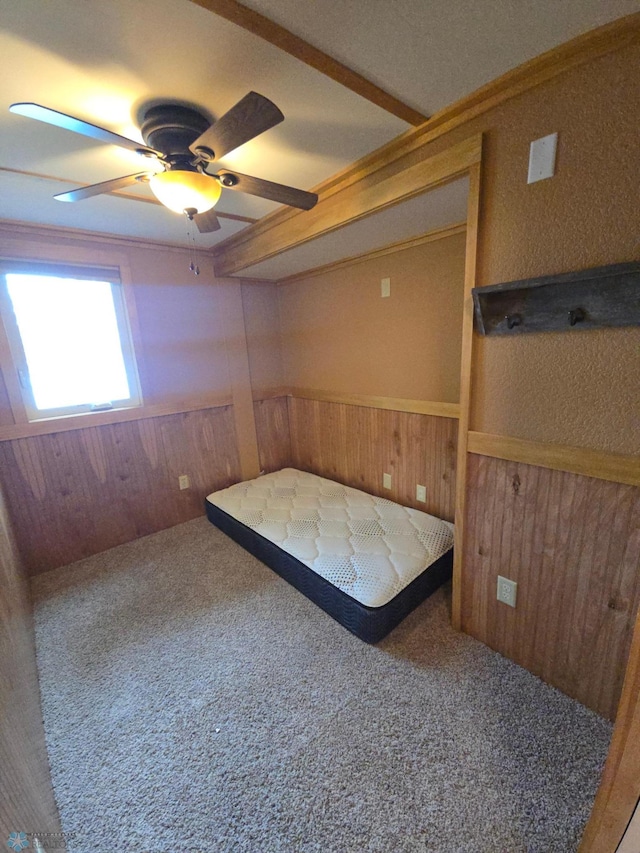 14768 Tradewinds Rd, Lake Eunice Twp, MN 56511 - carpeted bedroom with wood walls, a wainscoted wall, and a ceiling fan