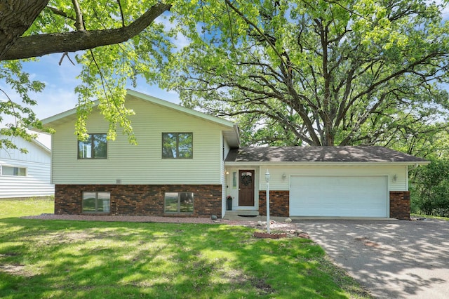 16503 Franklin Trl SE, Prior Lake, MN 55372 - split level home with brick siding, an attached garage, concrete driveway, and a front yard