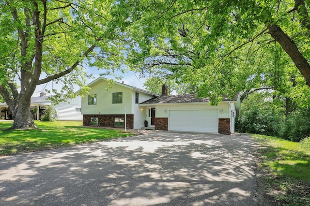 16503 Franklin Trl SE, Prior Lake, MN 55372 - tri-level home with driveway, an attached garage, a front lawn, a chimney, and brick siding