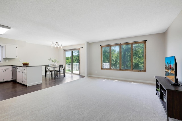 16503 Franklin Trl SE, Prior Lake, MN 55372 - living area with dark colored carpet, baseboards, a chandelier, and a textured ceiling