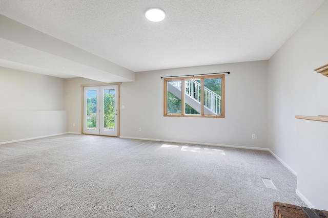 16503 Franklin Trl SE, Prior Lake, MN 55372 - carpeted empty room with healthy amount of natural light, a textured ceiling, and baseboards