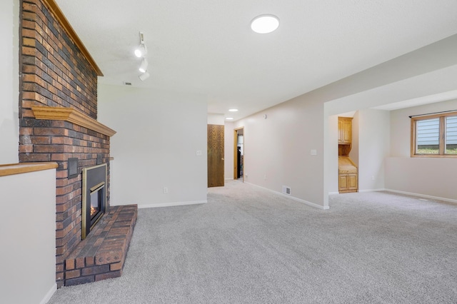 16503 Franklin Trl SE, Prior Lake, MN 55372 - unfurnished living room with a fireplace, light carpet, track lighting, and baseboards