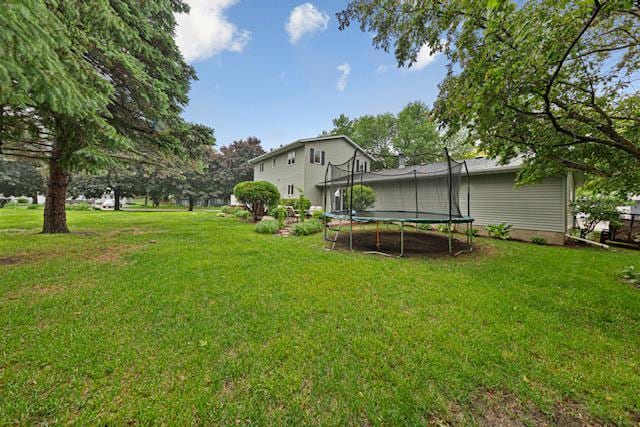 1525 21st Ave NW, Faribault, MN 55021 - view of green lawn featuring a trampoline