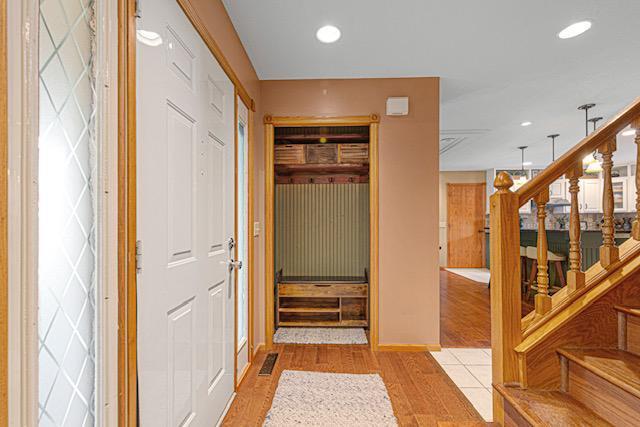 1525 21st Ave NW, Faribault, MN 55021 - hall with light wood-style floors, recessed lighting, baseboards, and stairs