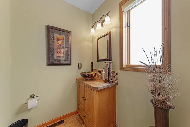 1525 21st Ave NW, Faribault, MN 55021 - bathroom featuring vanity and baseboards