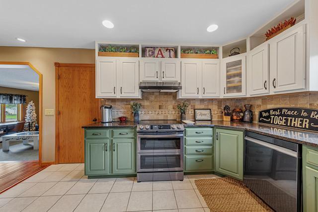 1525 21st Ave NW, Faribault, MN 55021 - kitchen featuring range with two ovens, green cabinets, under cabinet range hood, and recessed lighting